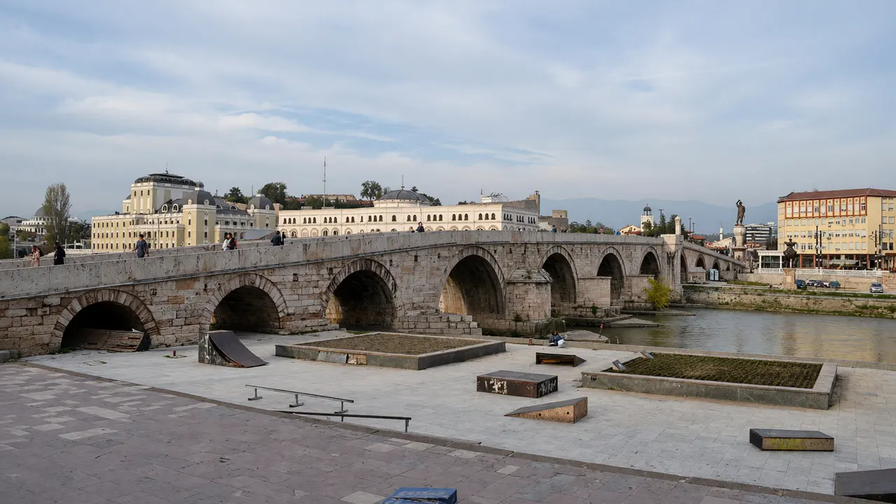 KI-Illustration: Steinbrücke und Stadtzentrum am Vardar in Skopje
